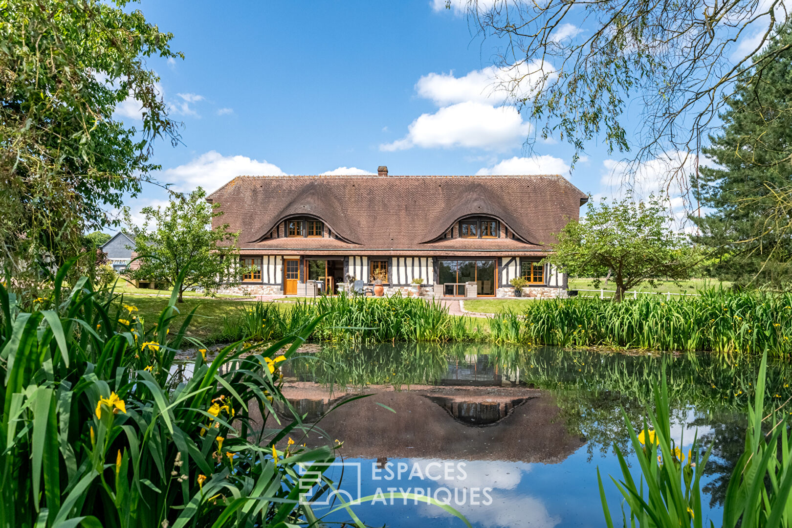 Norman house surrounded by nature and its outbuildings