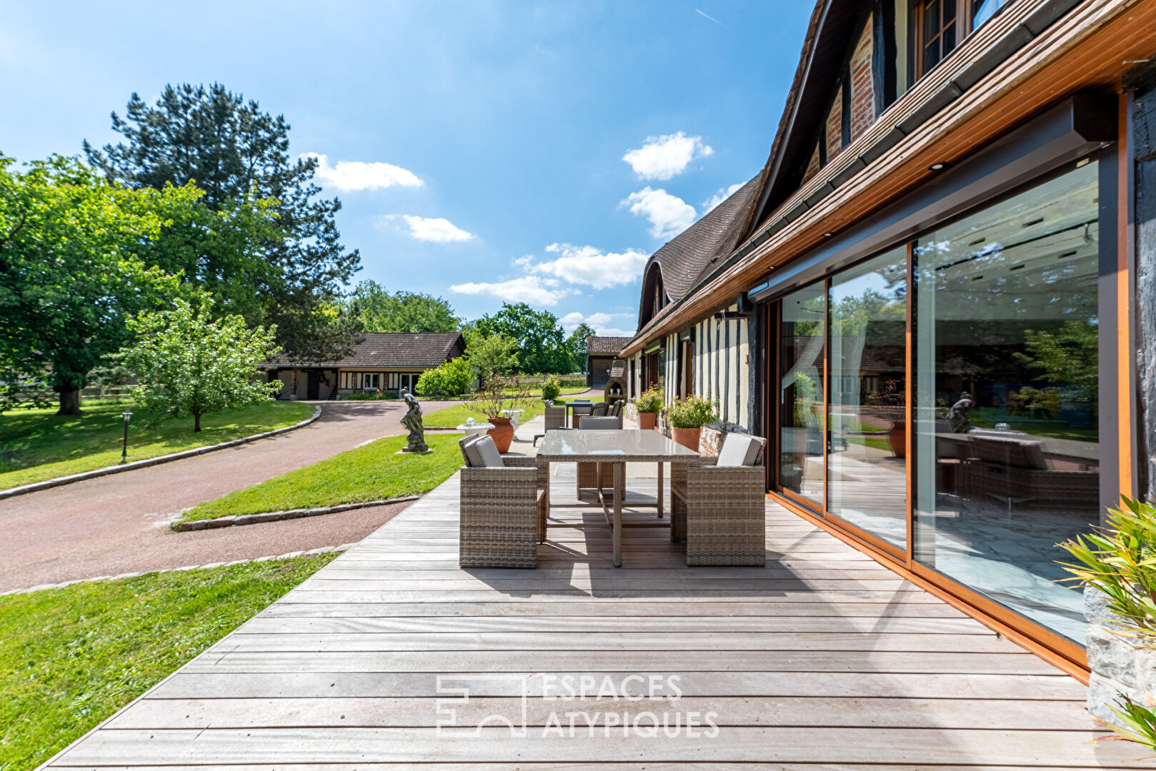 Norman house surrounded by nature and its outbuildings