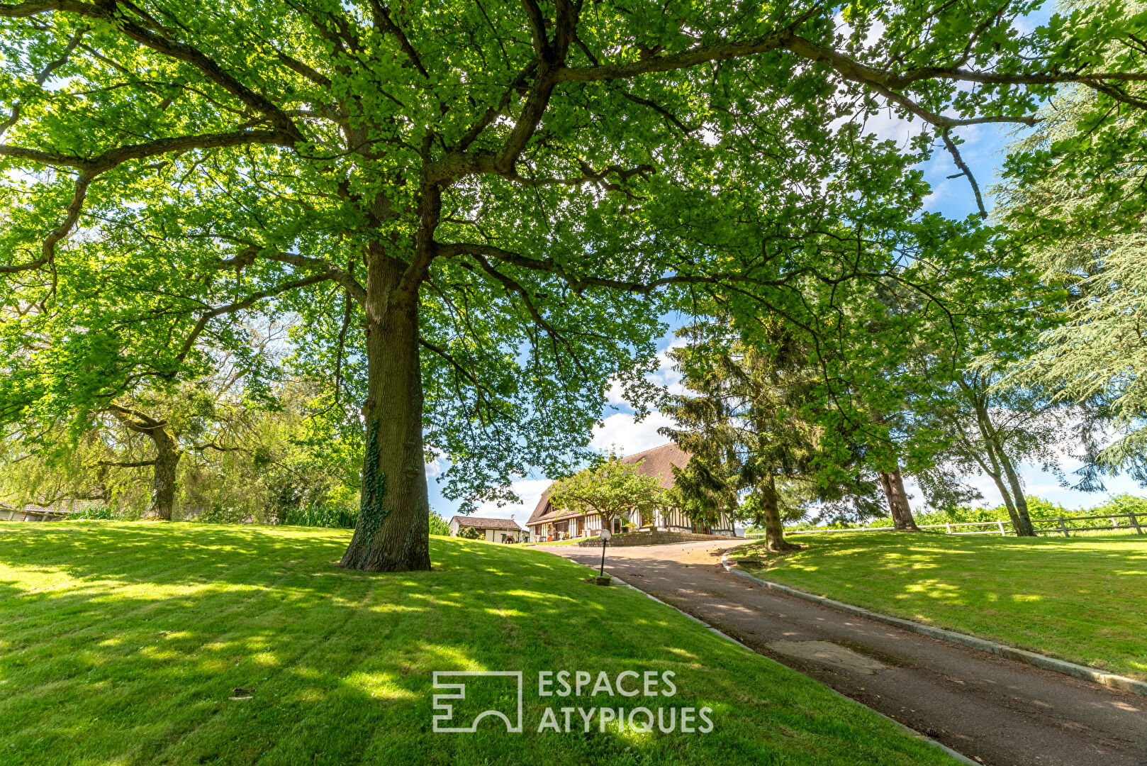 Norman house surrounded by nature and its outbuildings