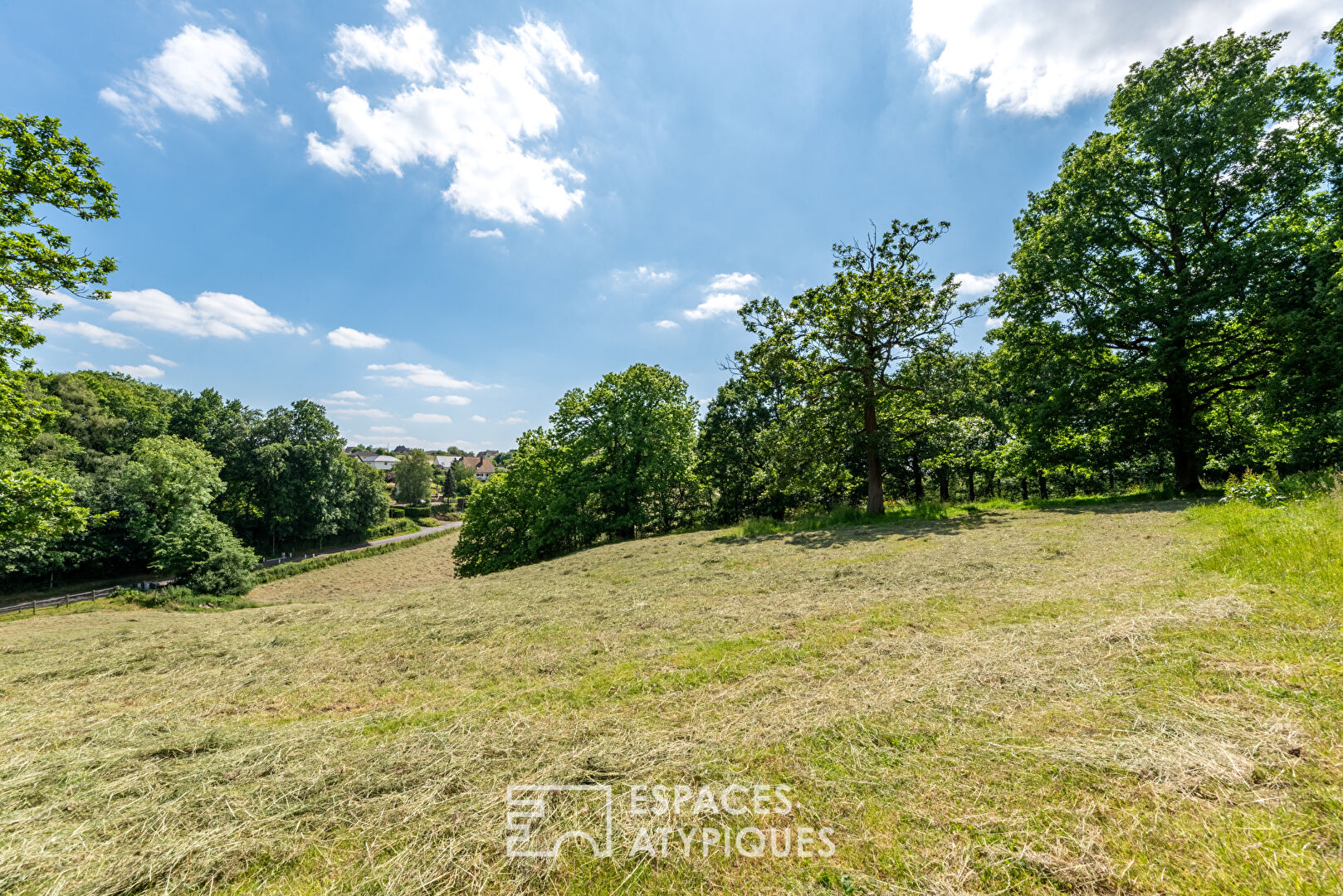 Norman house surrounded by nature and its outbuildings