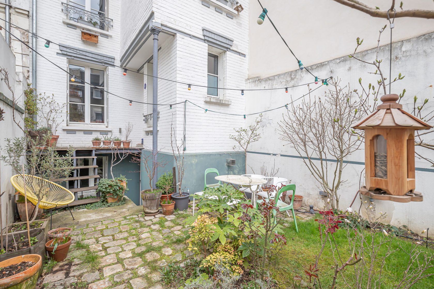 House with garden and paved courtyard