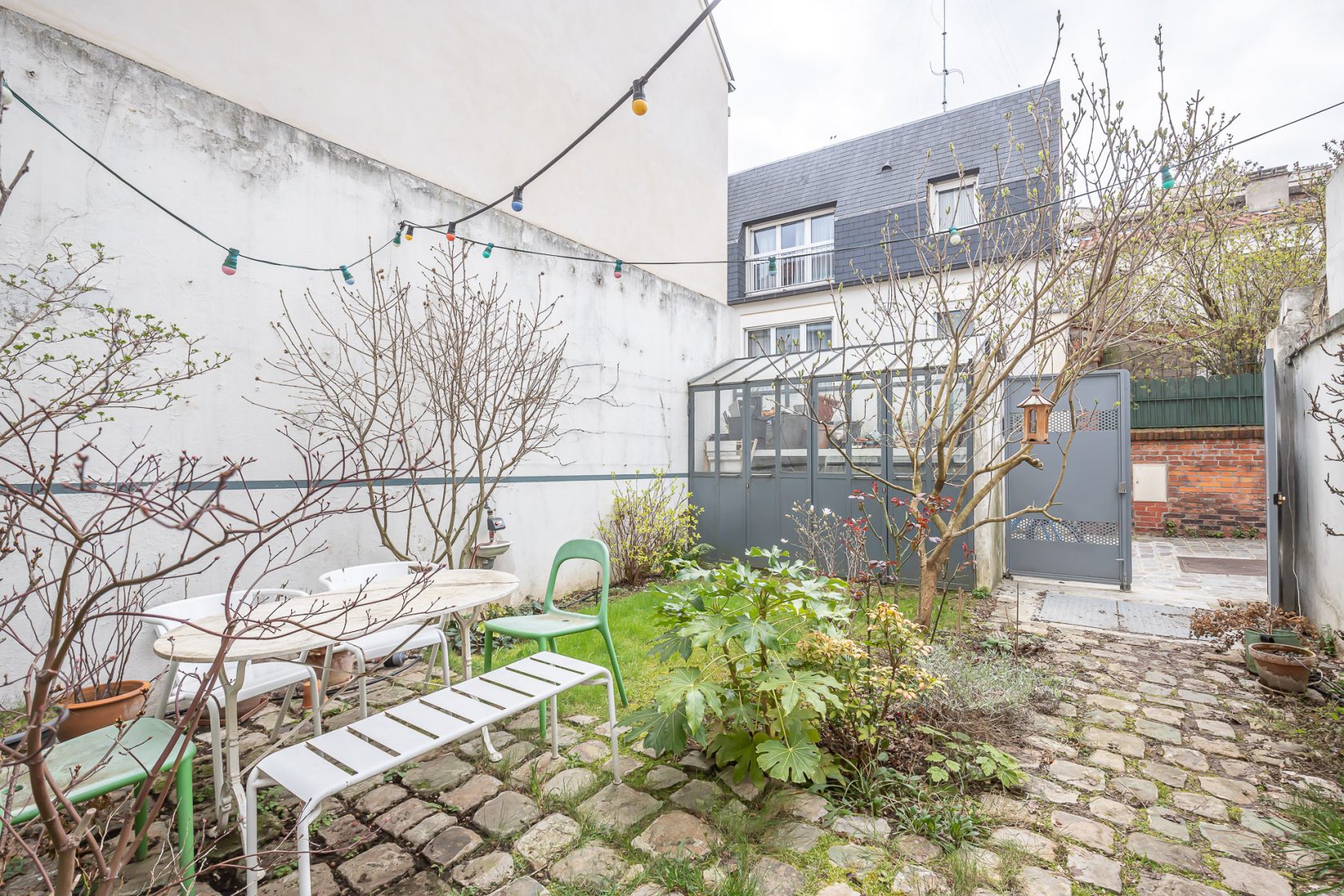 House with garden and paved courtyard
