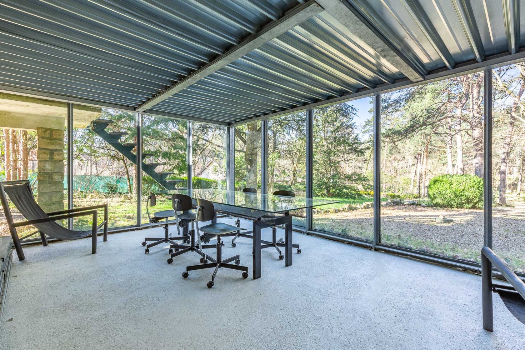 House with its glass extension nestled in the forest