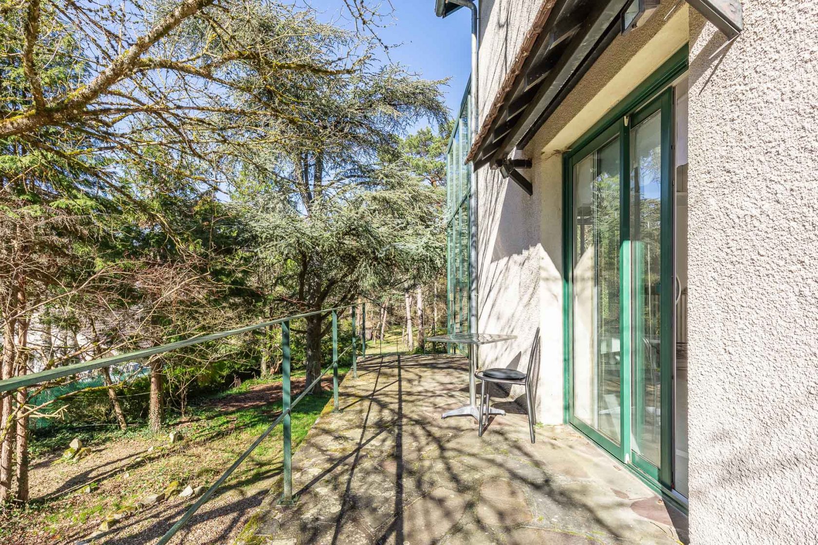 Maison avec son extension verrière nichée dans la forêt