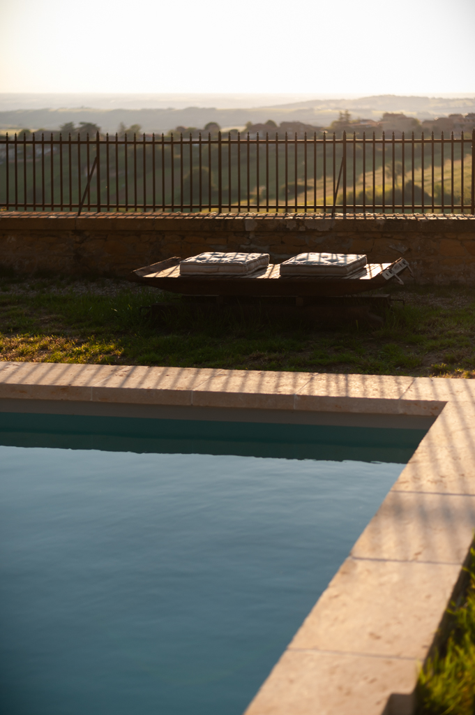Golden stone building with swimming pool and outbuilding