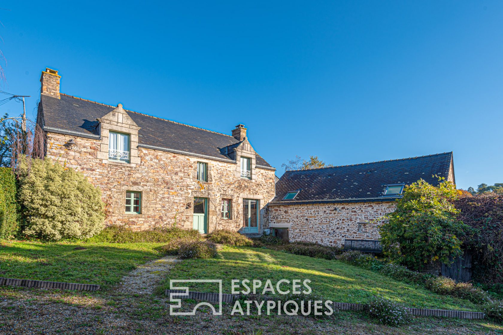 Group of stone buildings with swimming pool and river view