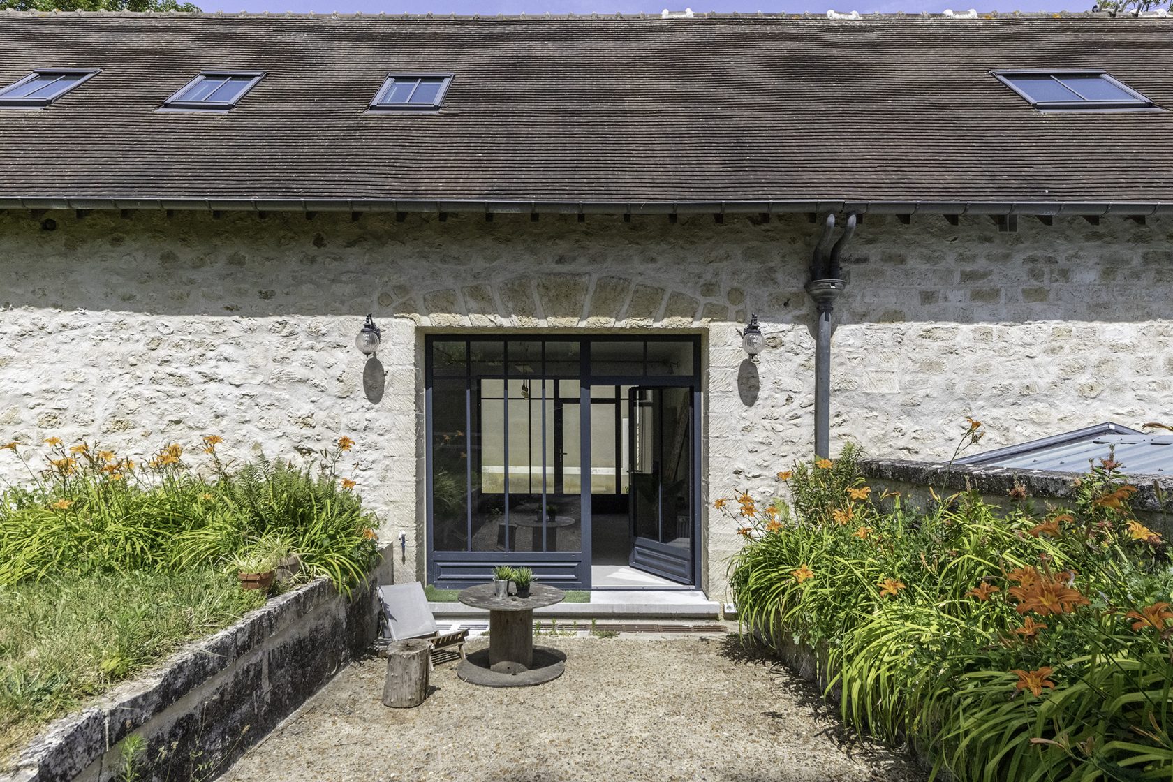 Former tack room converted into a dwelling and its three horse boxes.