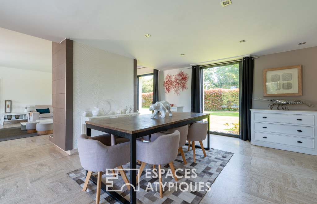 Large architect-designed waterfront house with park and swimming pool.