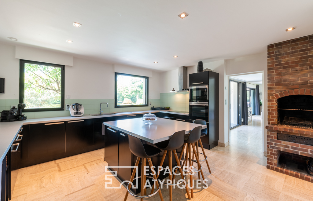 Large architect-designed waterfront house with park and swimming pool.