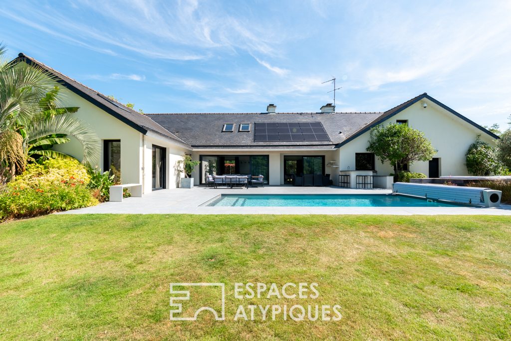 Large architect-designed waterfront house with park and swimming pool.