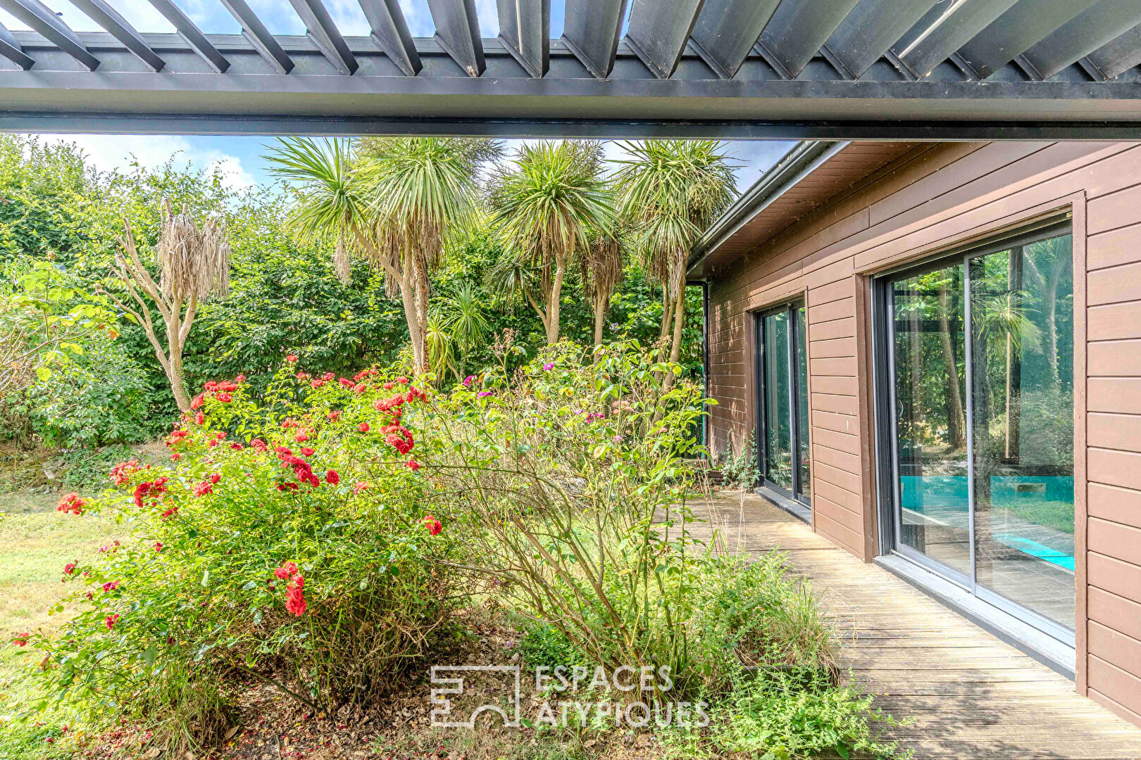 Villa contemporaine avec piscine intérieure dans un écrin de verdure.