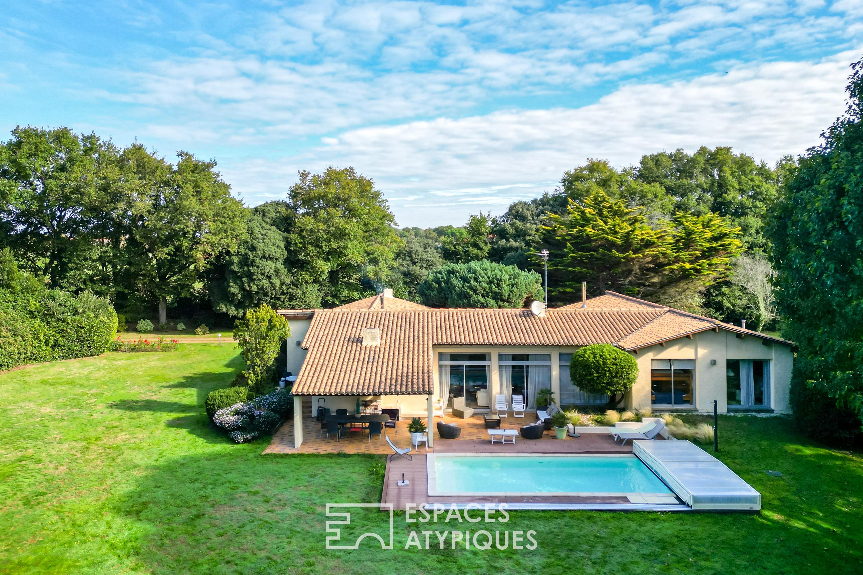 Single-story property with swimming pool in landscaped grounds