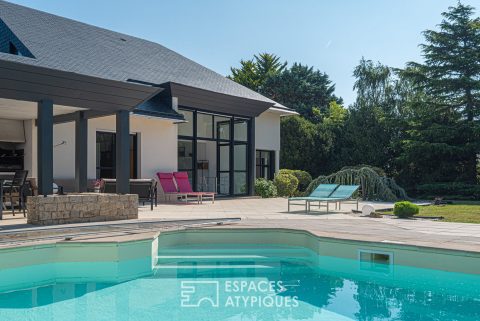 Architect house with pool at the heart of lush vegetation