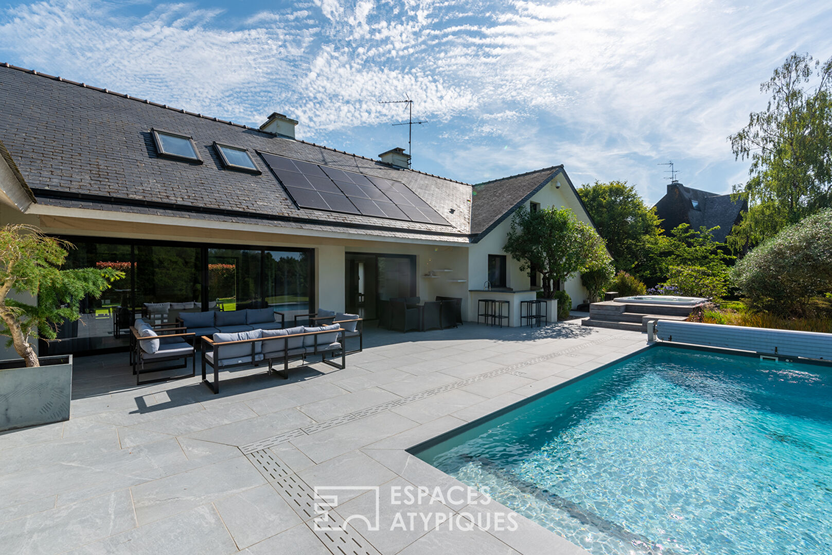 Large architect-designed waterfront house with park and swimming pool.