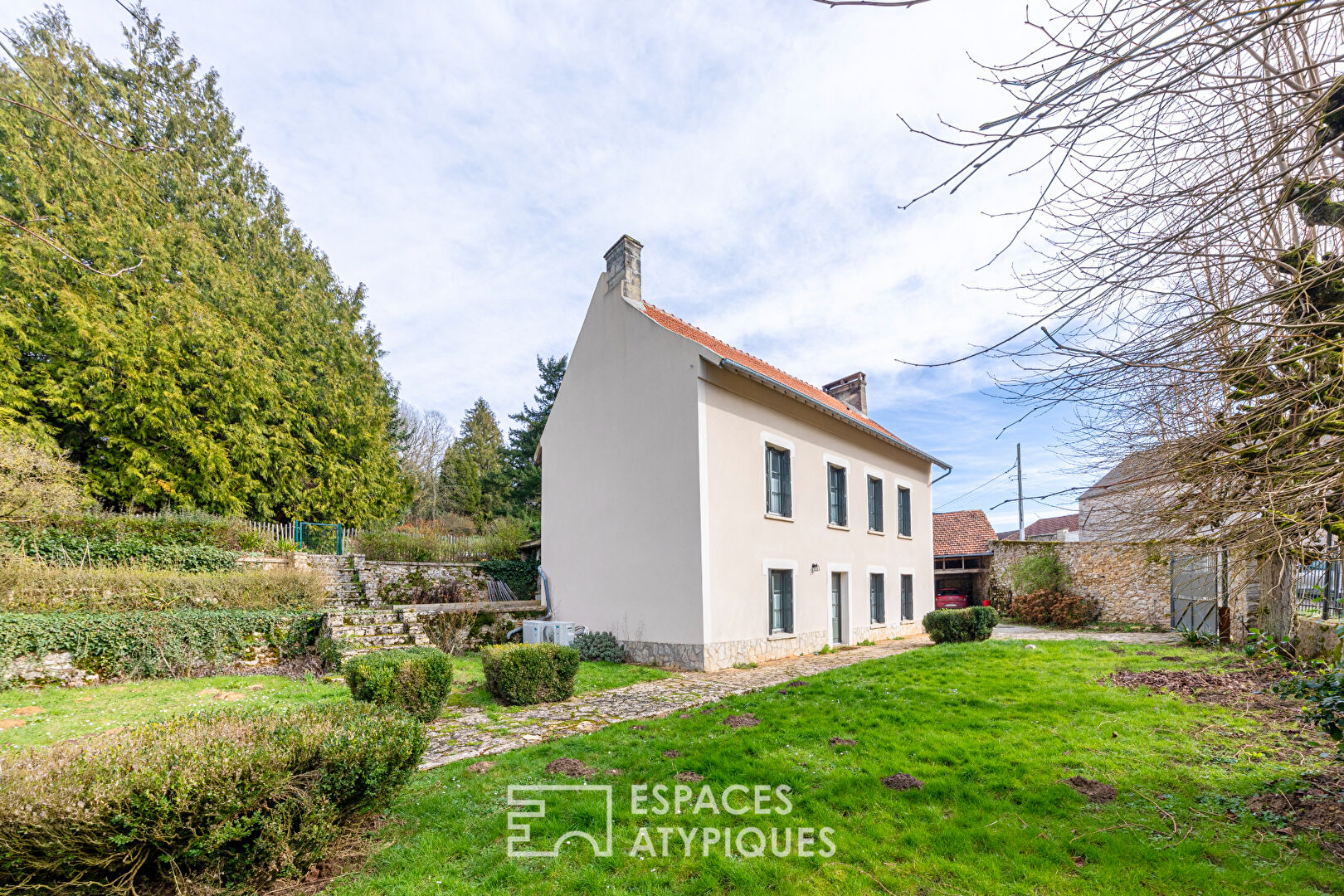 Completely renovated property, its outbuildings, and its wooded park.