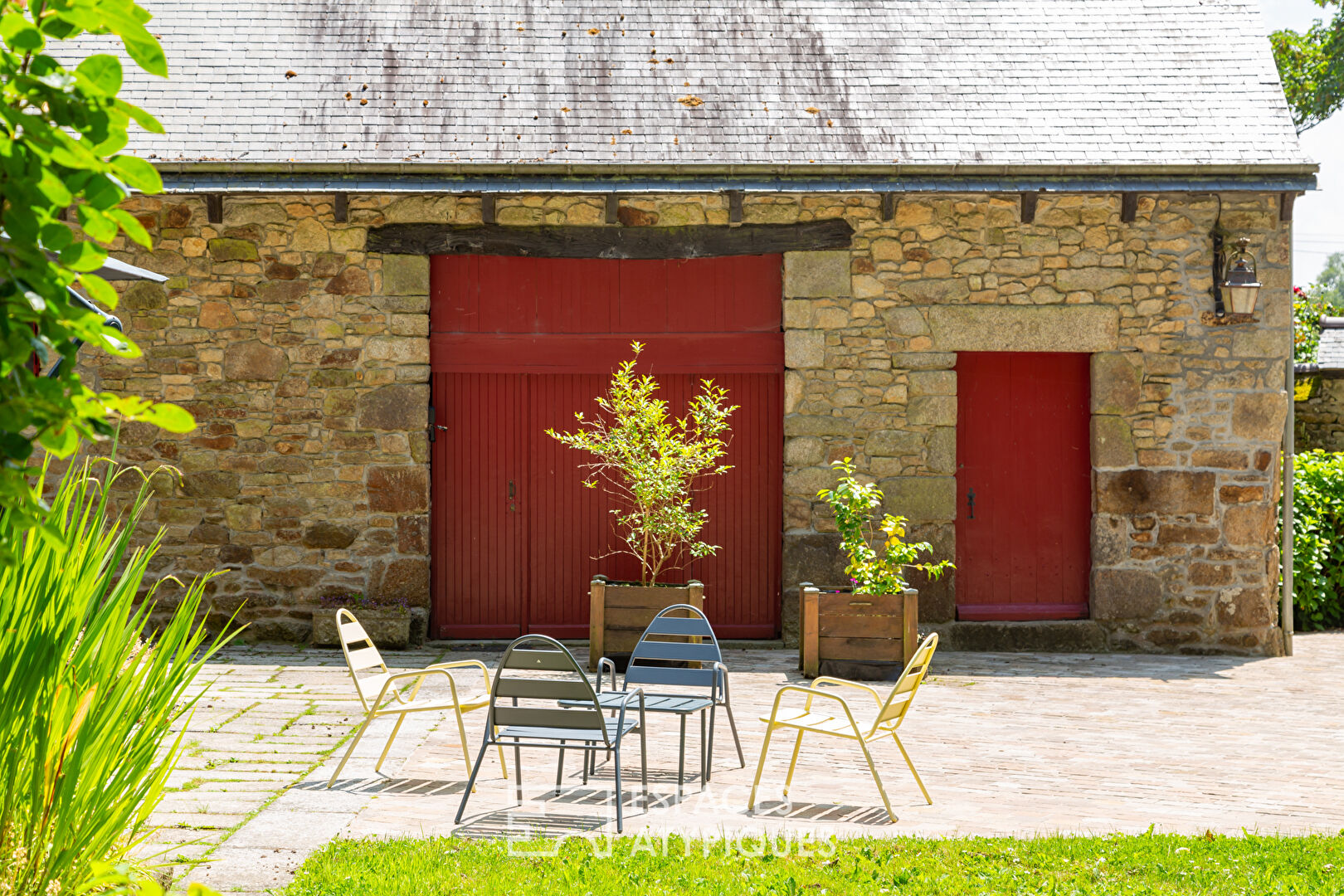 Old renovated mill with outbuildings in a green setting
