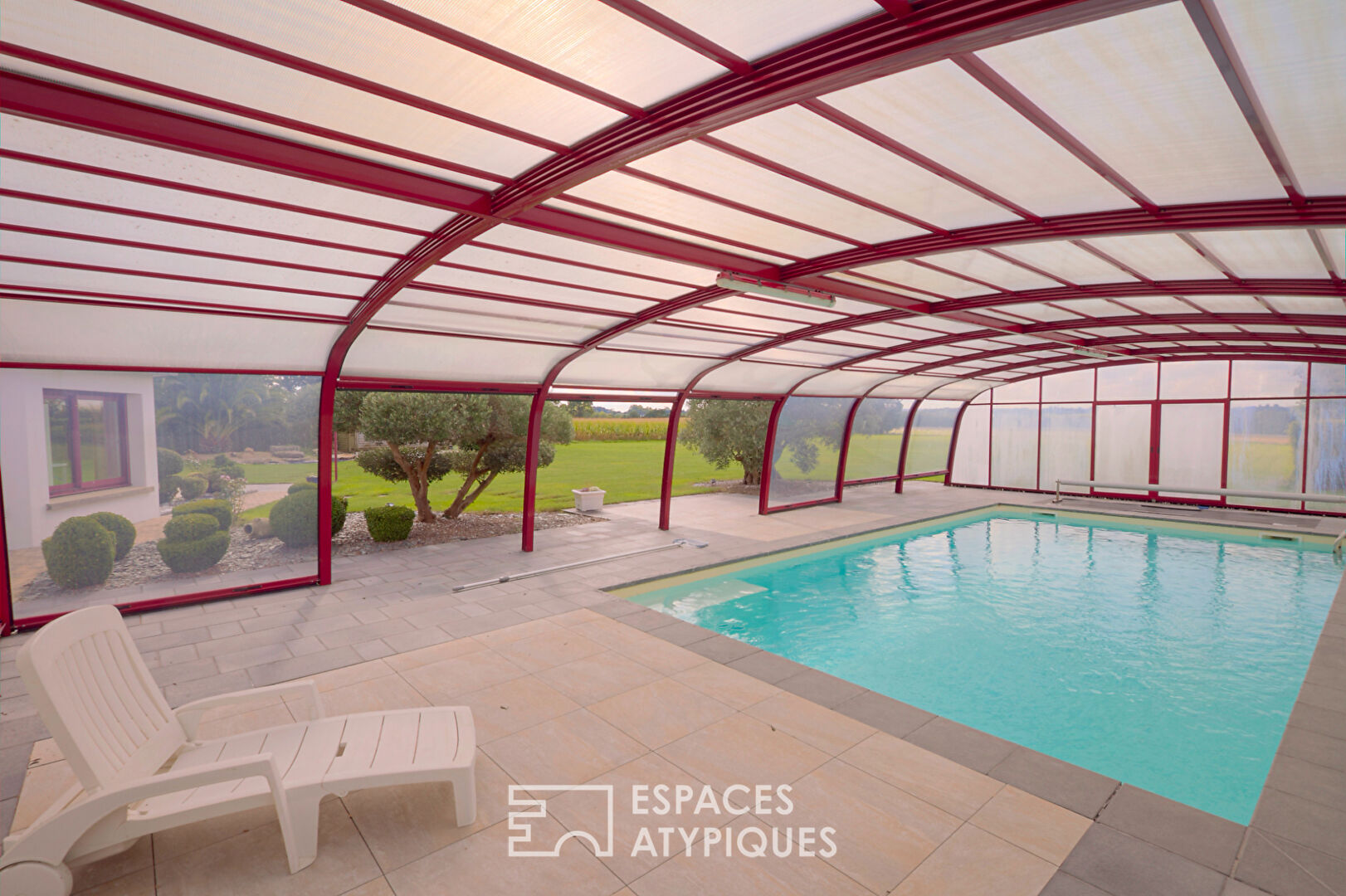 Single-storey house with covered swimming pool