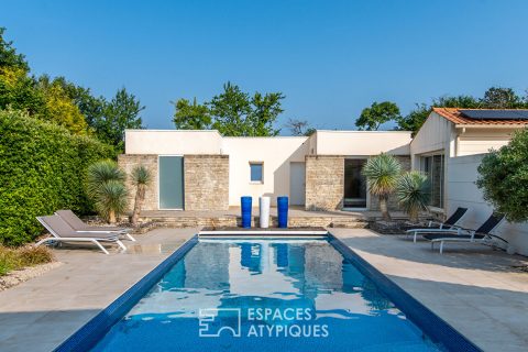 Single-story architect-designed house with swimming pool and outbuildings