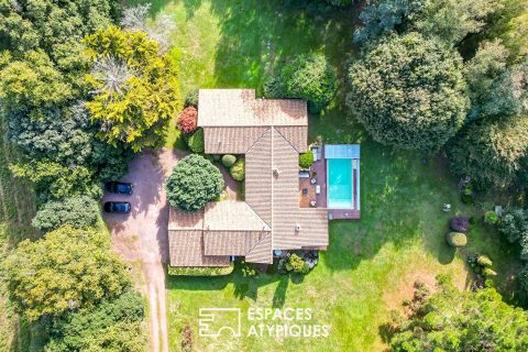 Single-story property with swimming pool in landscaped grounds