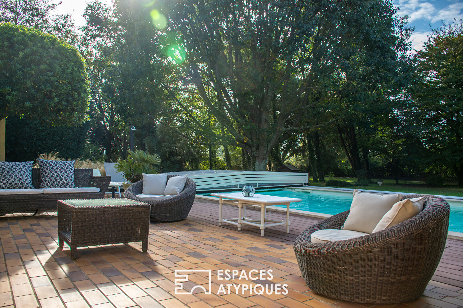 Single-story property with swimming pool in landscaped grounds