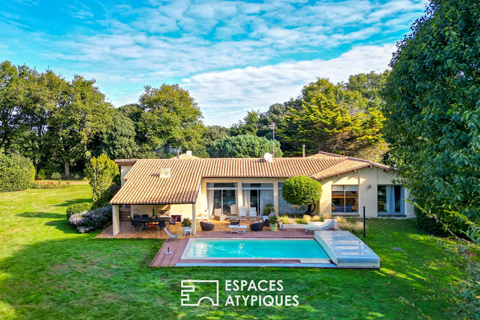 Single-story property with swimming pool in landscaped grounds