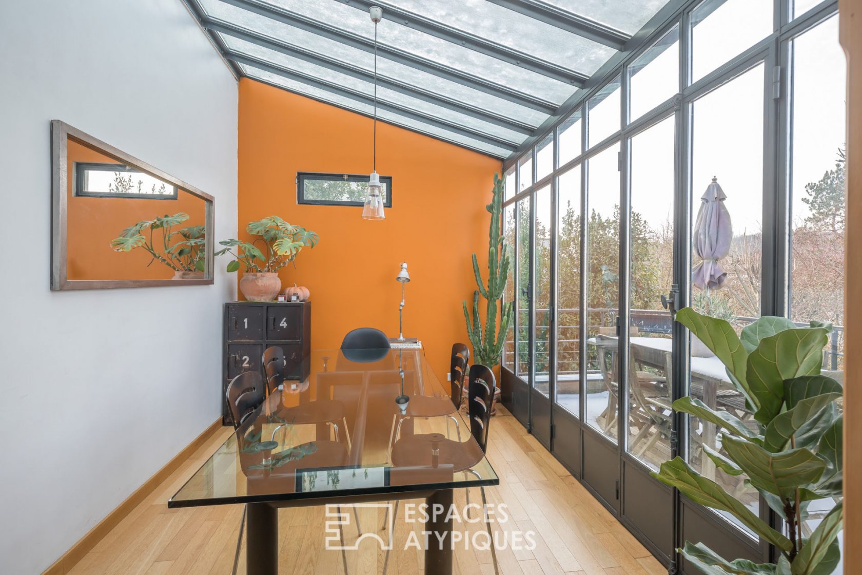 House with glass roof and garden on the edge of the forest
