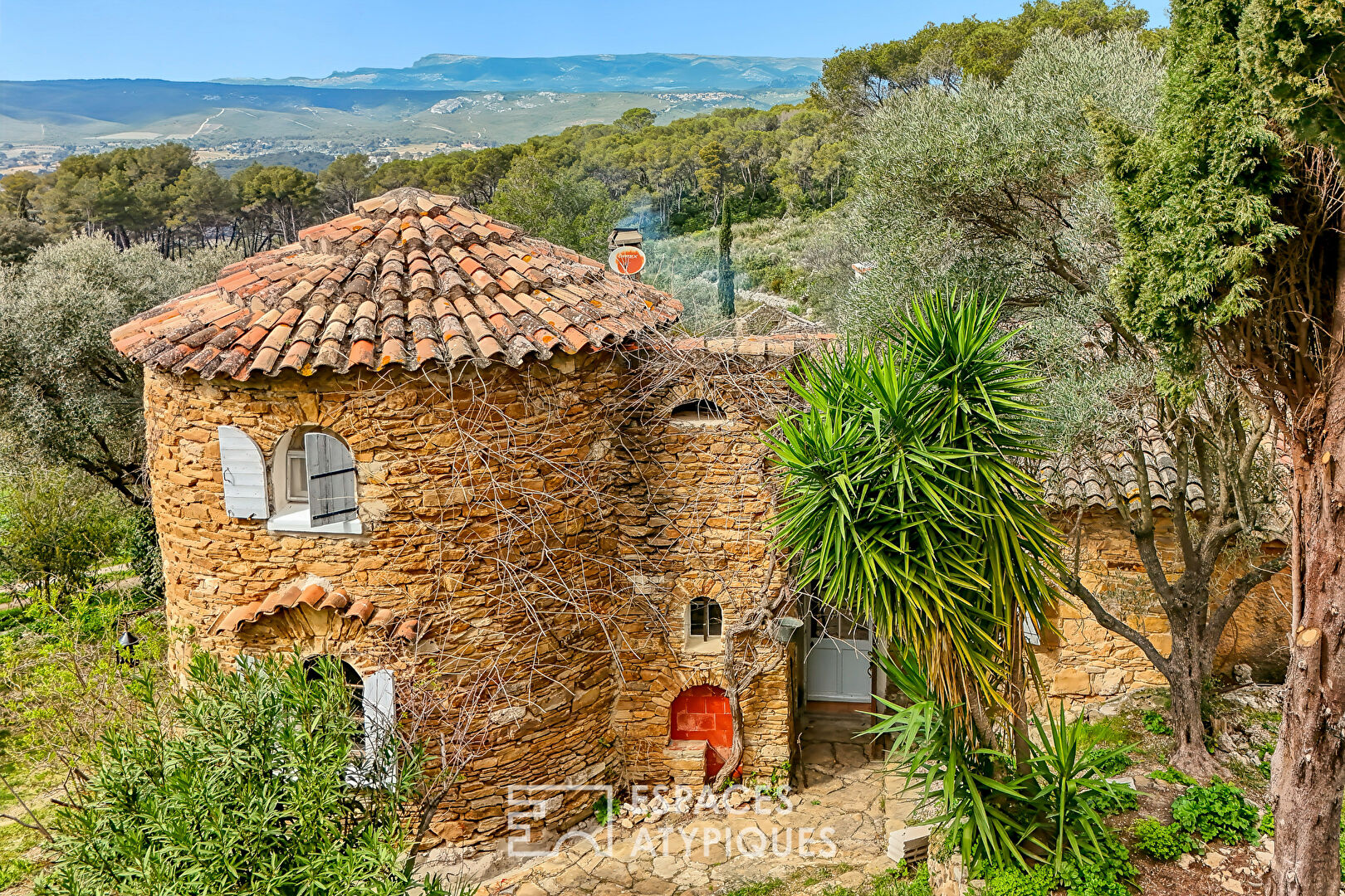Stone house surrounded by nature with swimming pool