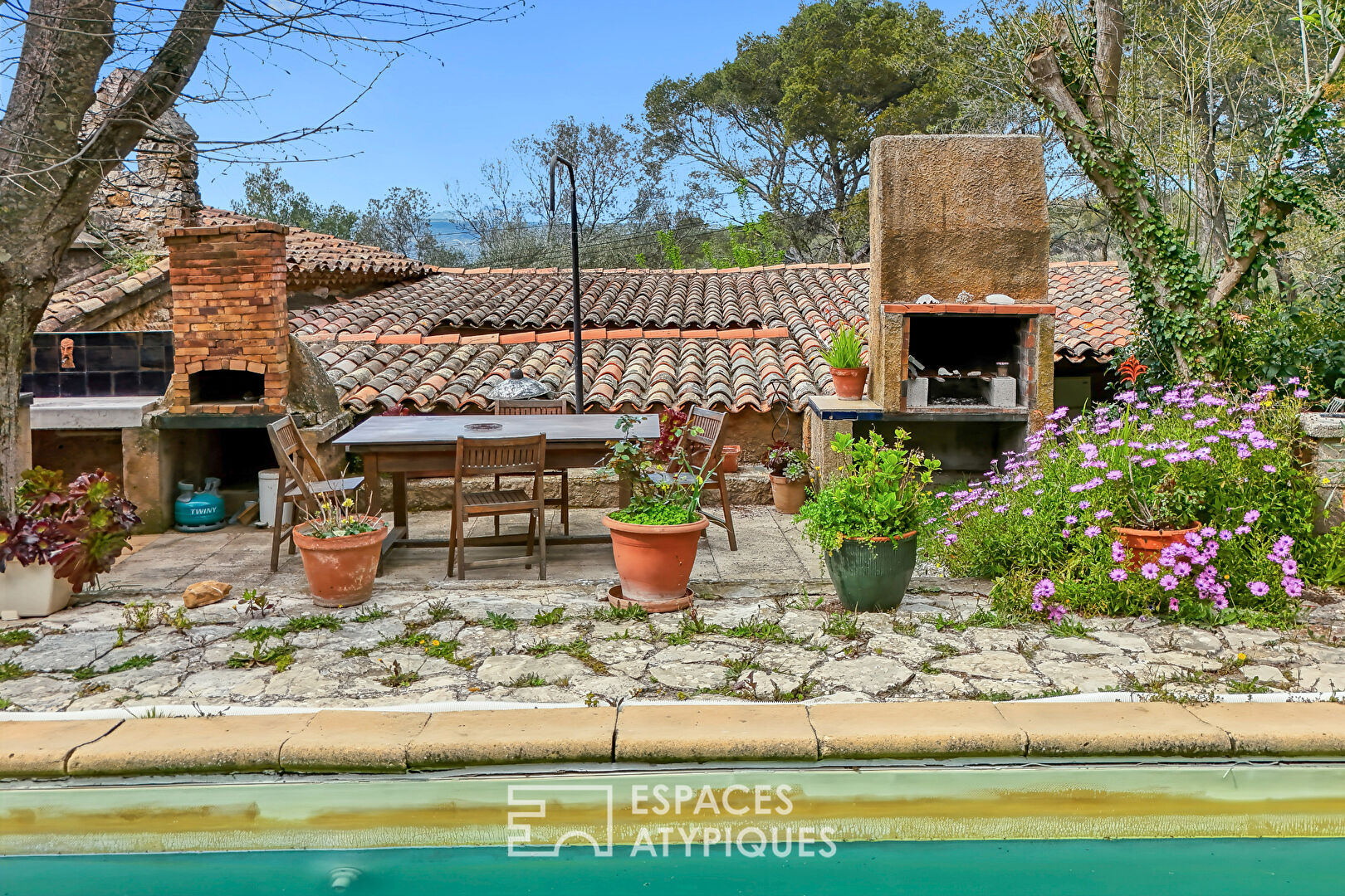 Stone house surrounded by nature with swimming pool