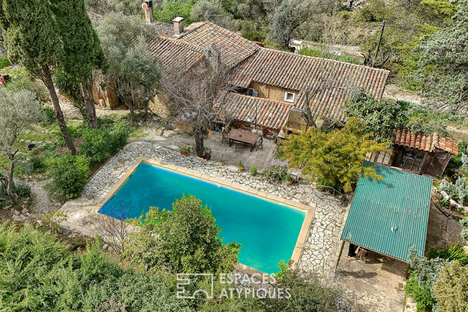 Stone house surrounded by nature with swimming pool