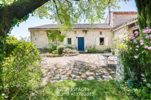 Batisse en pierre avec piscine dans un écrin de verdure