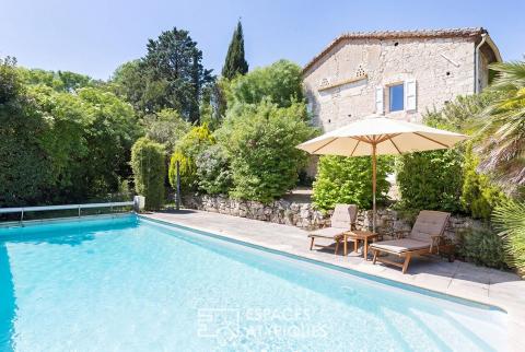 Batisse en pierre avec piscine dans un écrin de verdure