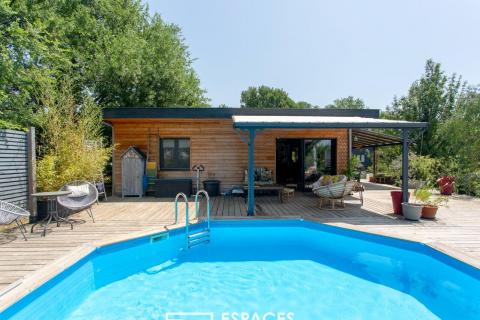 Wooden house in a peaceful setting with a swimming pool