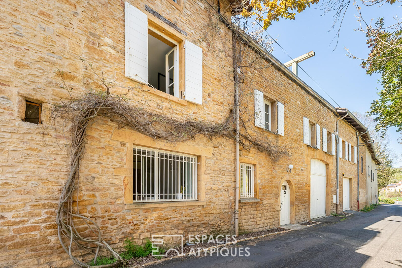 Maison en pierres dorées avec terrasse sur le toit