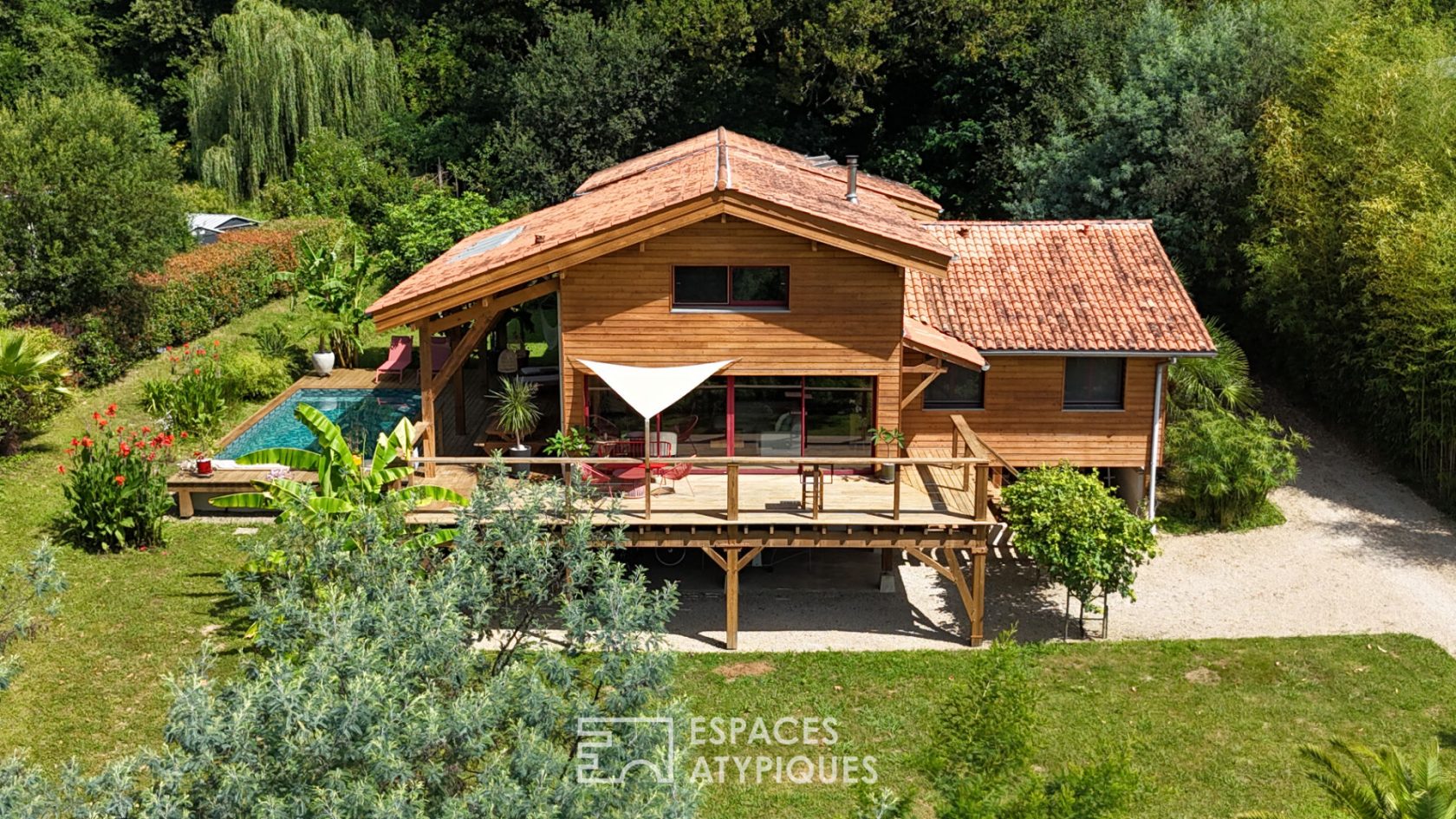 The elegant wooden house in its green setting