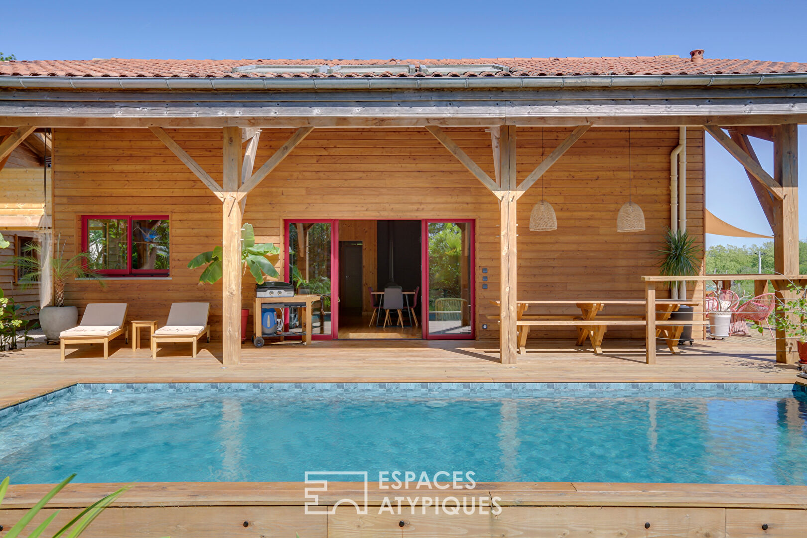 The elegant wooden house in its green setting