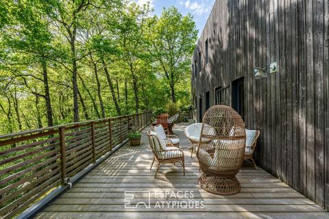 Timber-framed house with terrace and garden in a natural setting