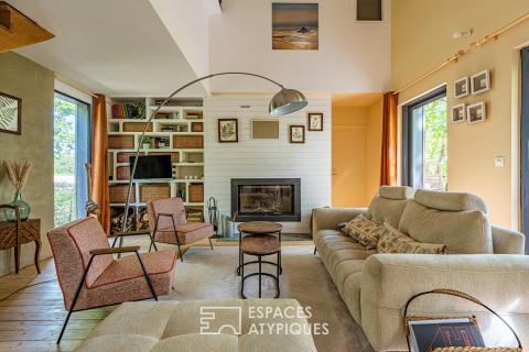 Timber-framed house with terrace and garden in a natural setting