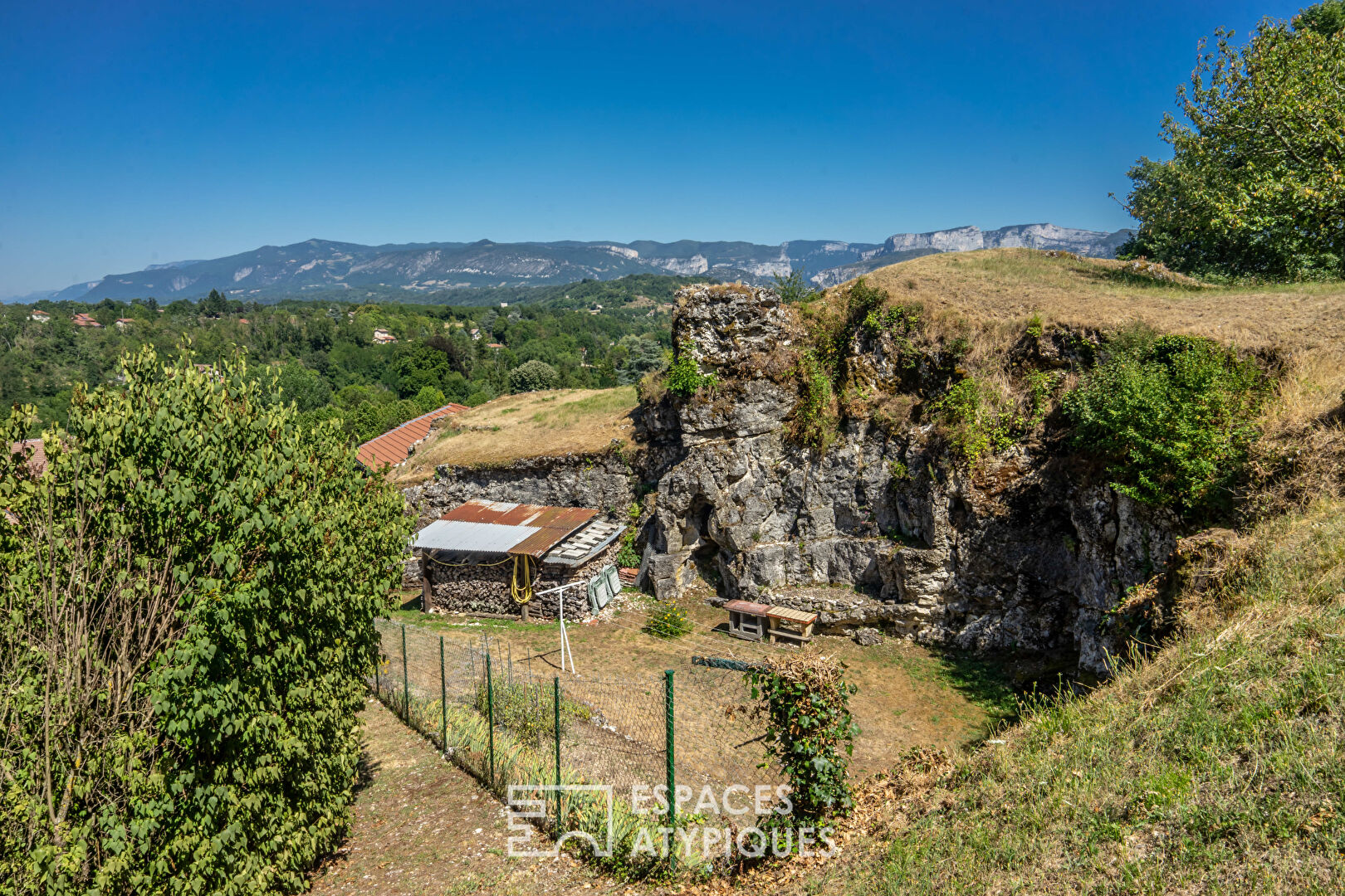 House built on a rock at the foot of the Vercors mountains