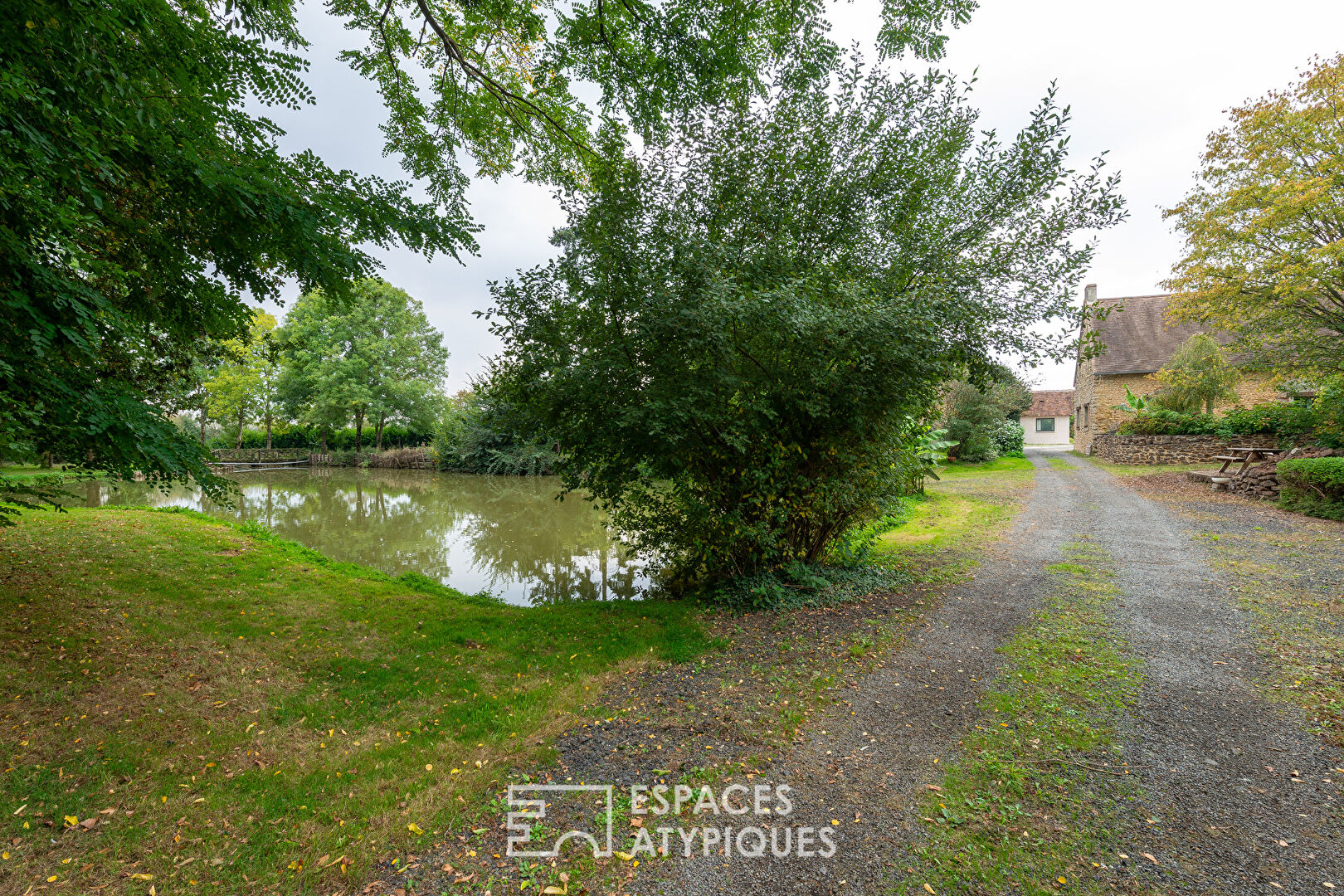 Large property with outbuildings and lake