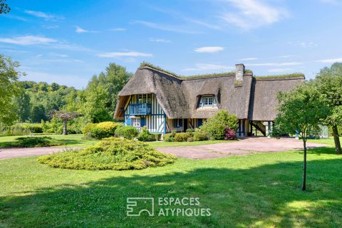 Noble thatched cottage and its park crossed by the Bec