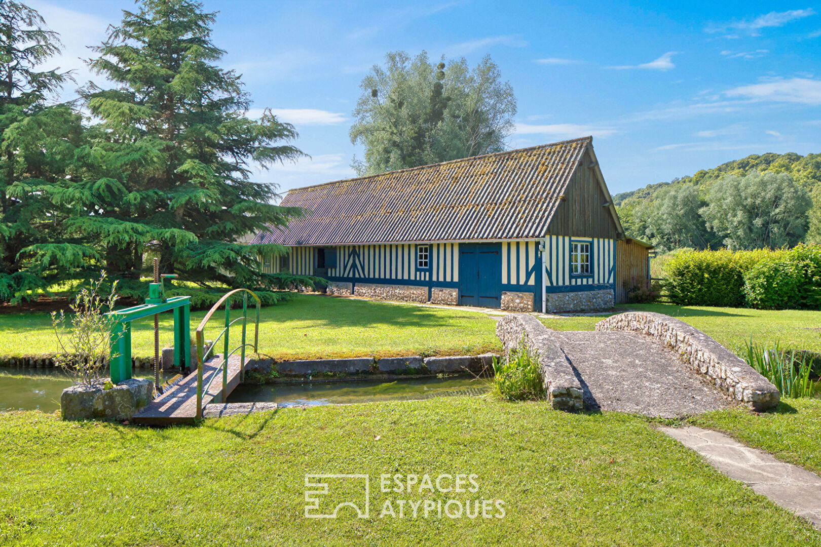 Noble thatched cottage and its park crossed by the Bec