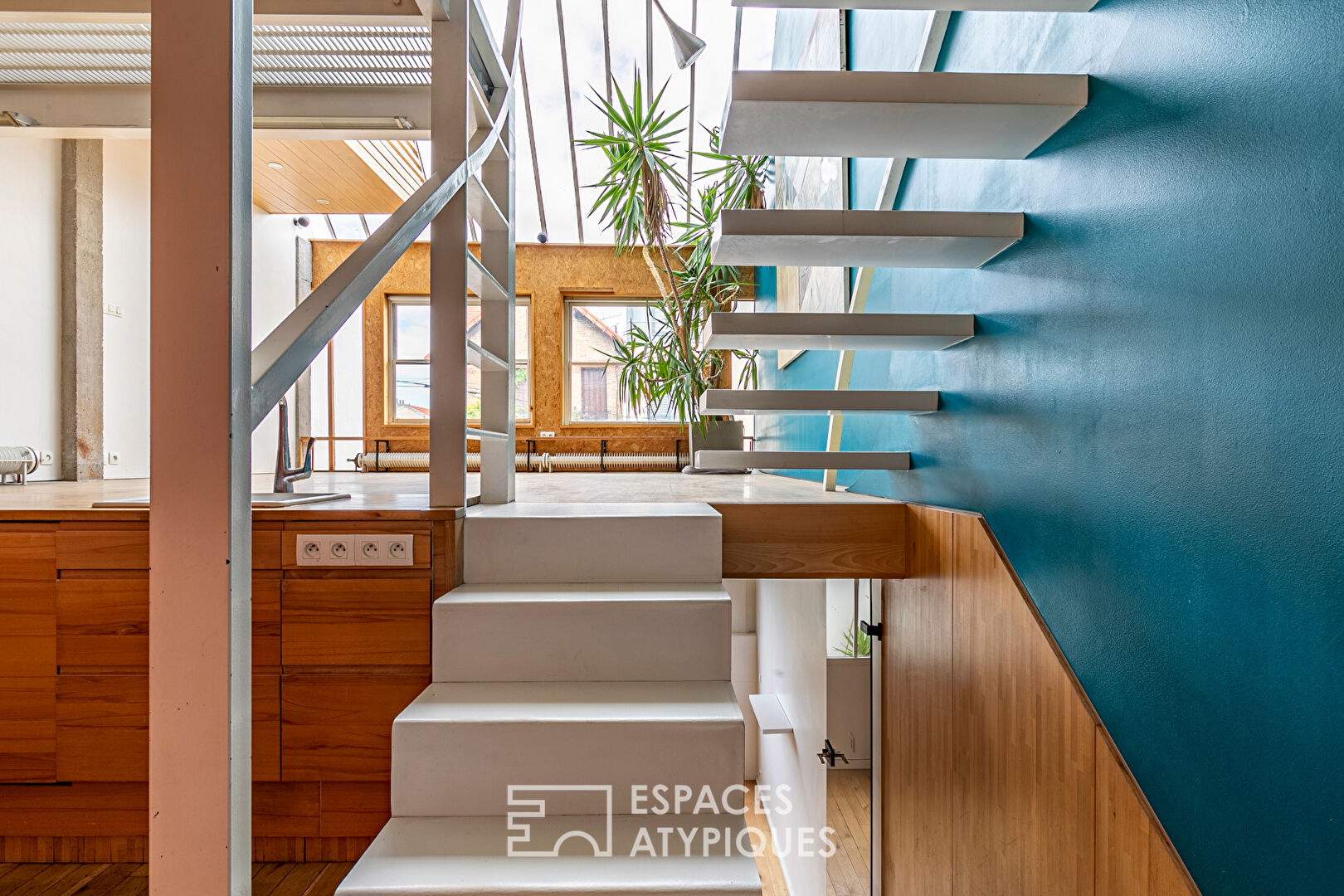 Artist’s loft with cascading glass roofs
