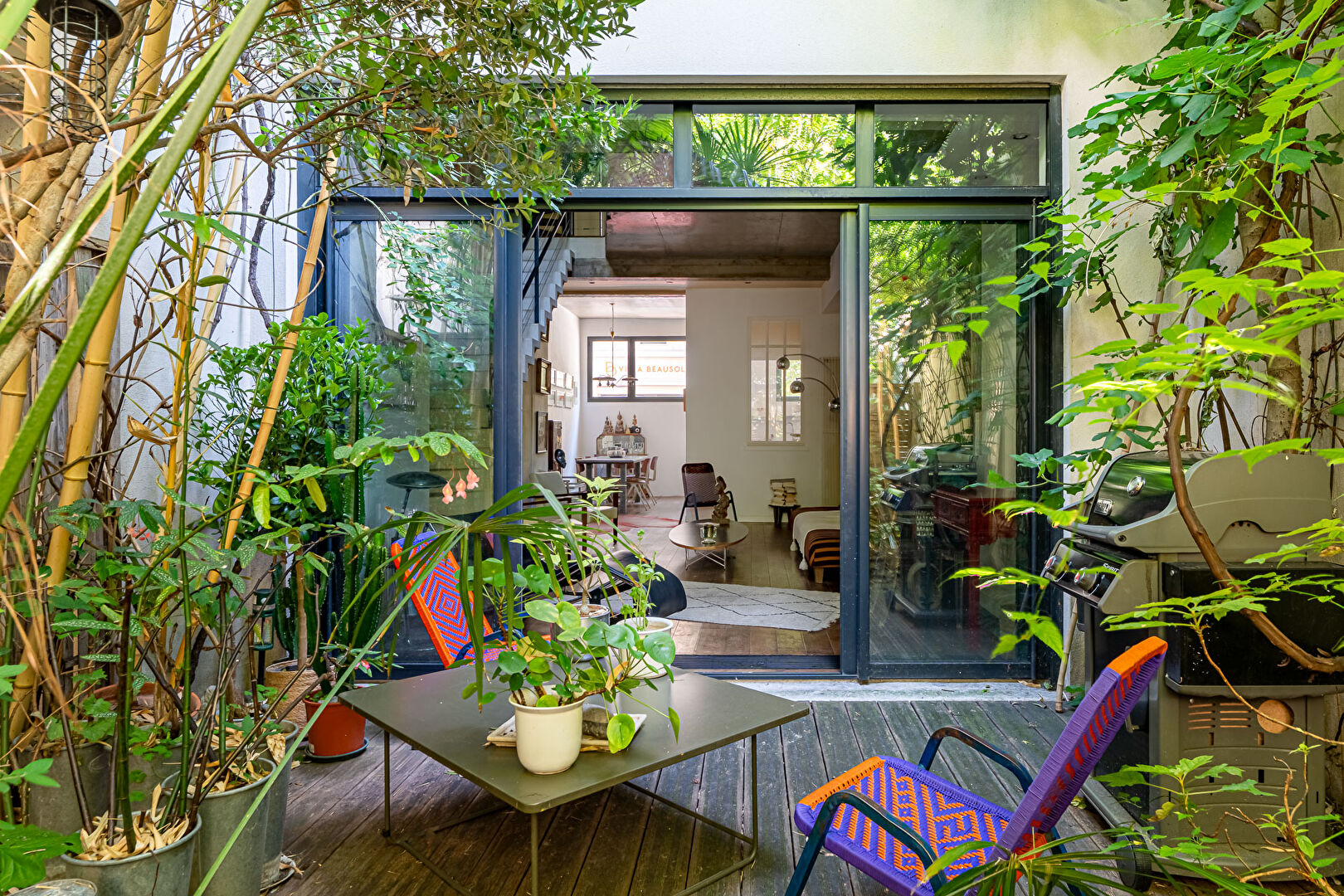 Architect-designed triplex with a house-style feel and a lush garden