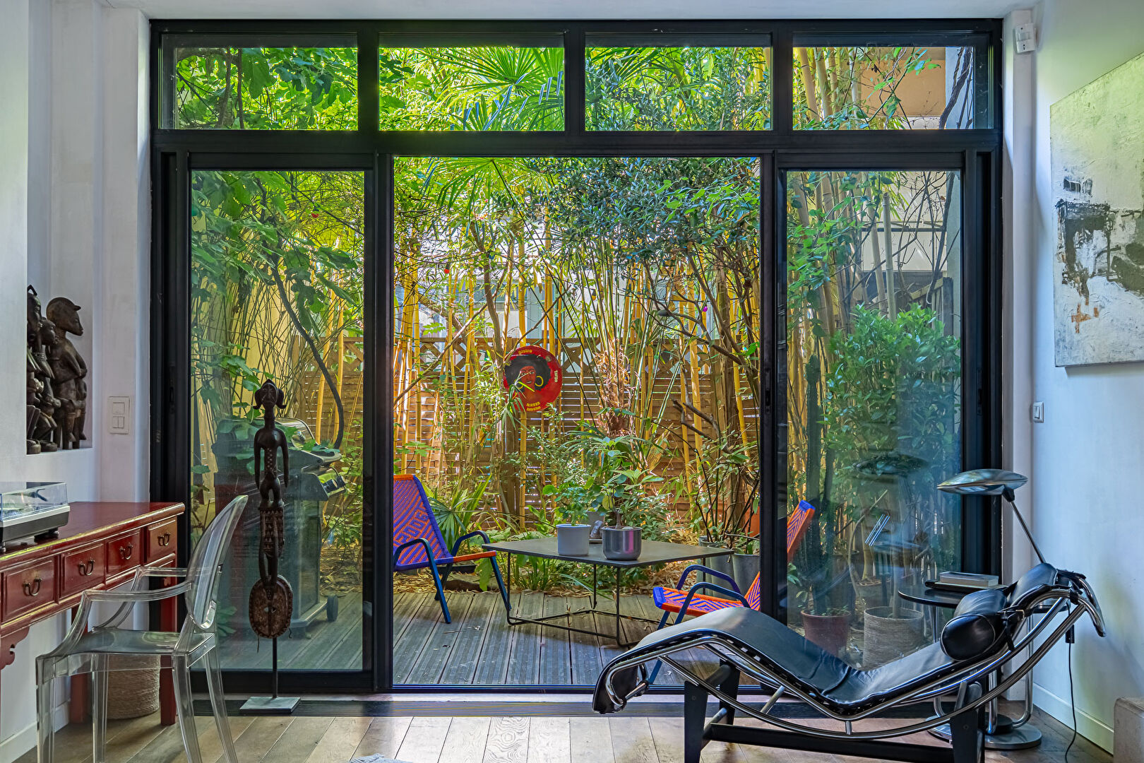 Architect-designed triplex with a house-style feel and a lush garden