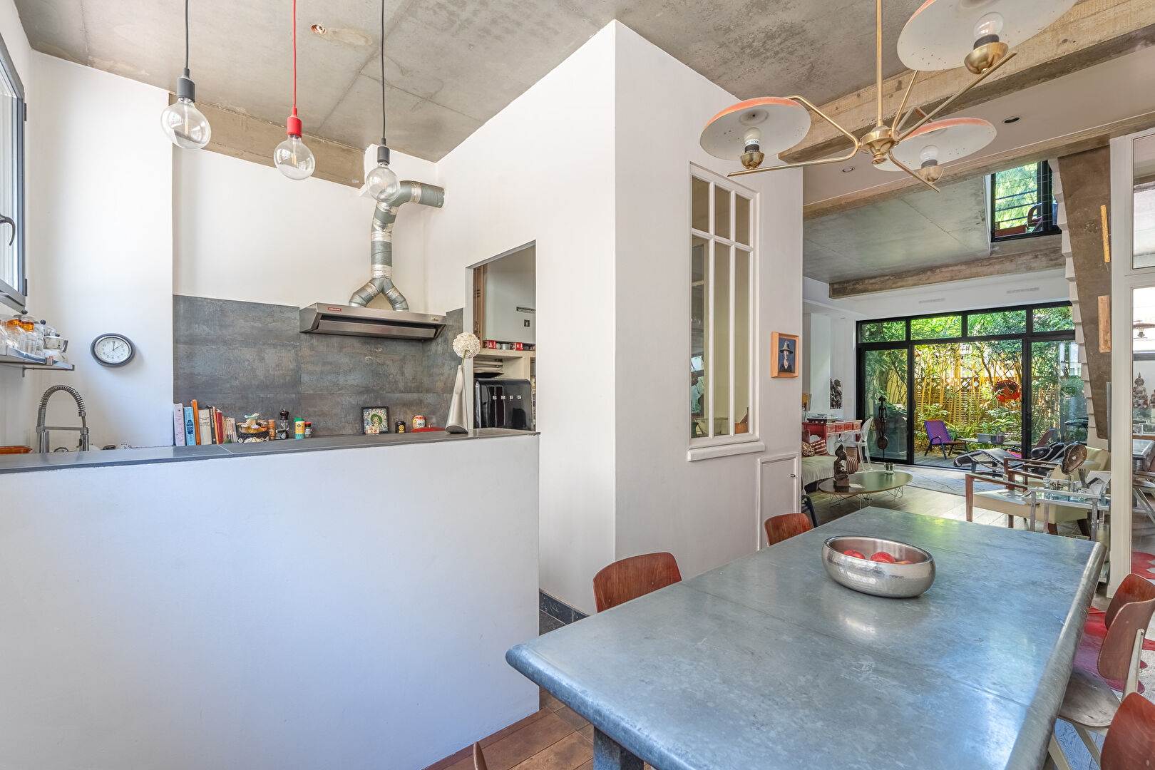 Architect-designed triplex with a house-style feel and a lush garden
