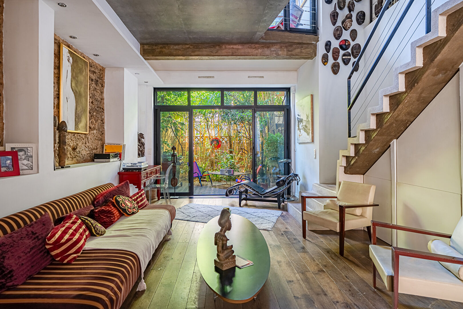 Architect-designed triplex with a house-style feel and a lush garden
