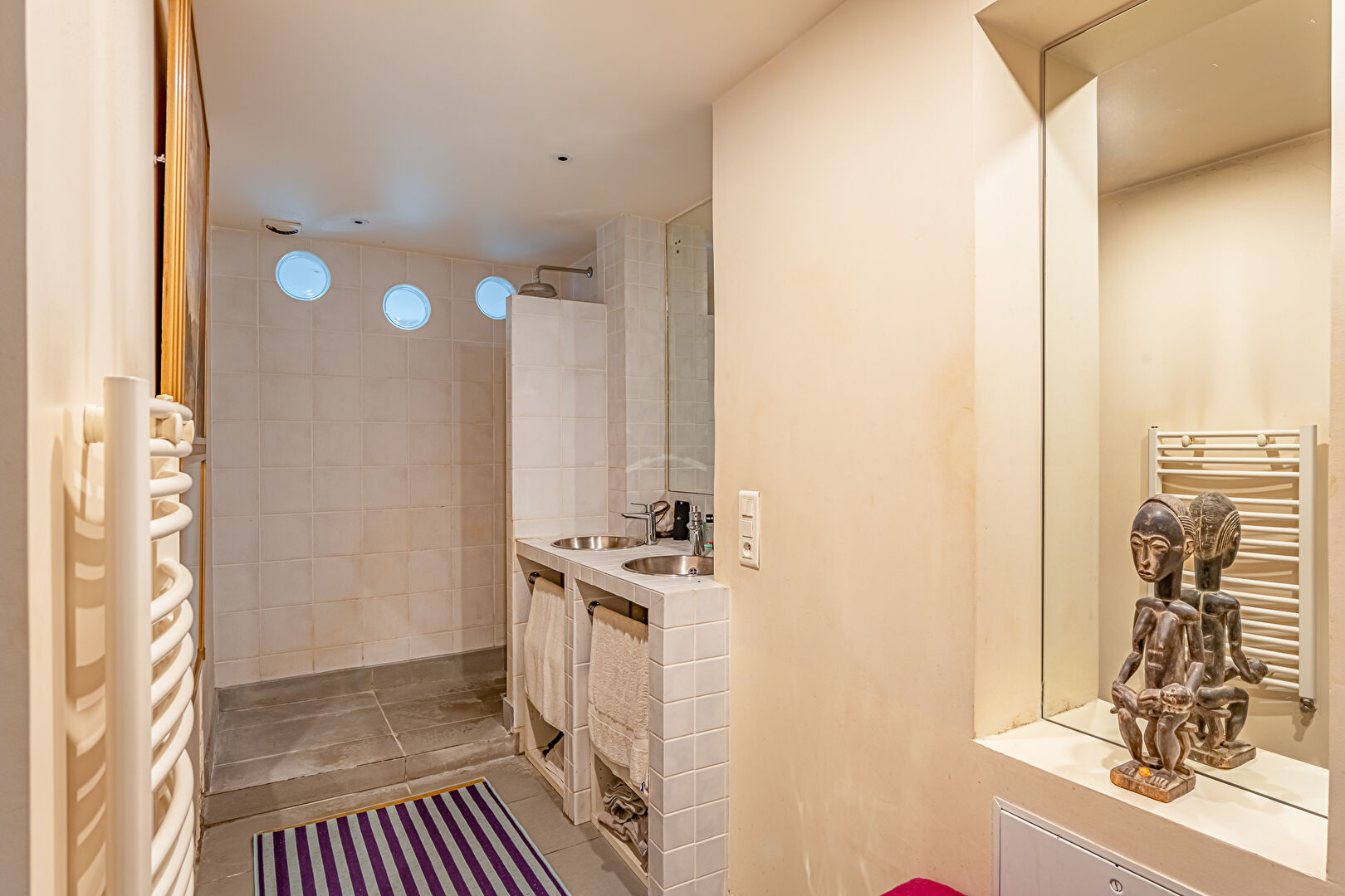 Architect-designed triplex with a house-style feel and a lush garden