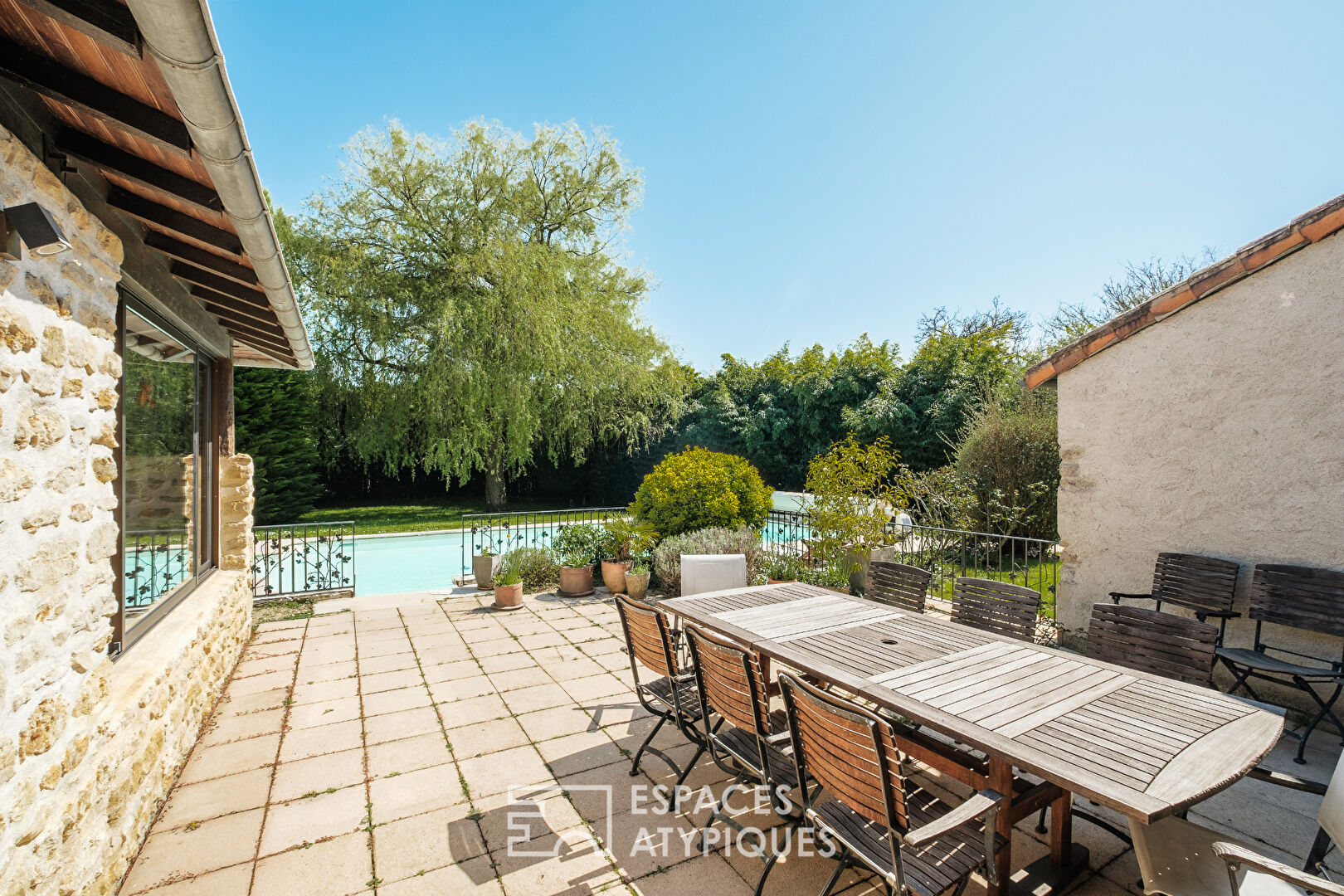 Former 15th century mill reinvented with swimming pool at the foot of a castle