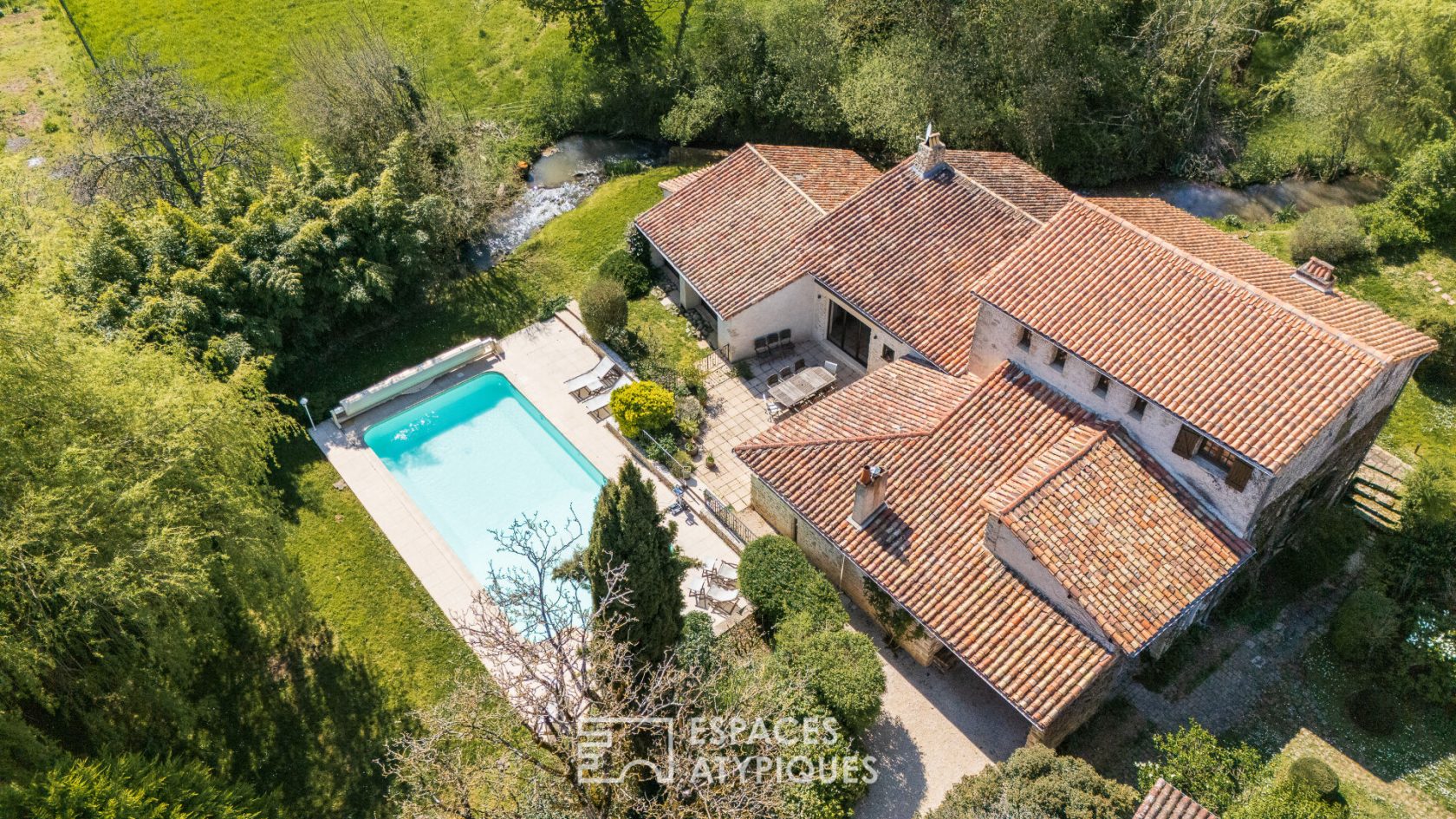Former 15th century mill reinvented with swimming pool at the foot of a castle