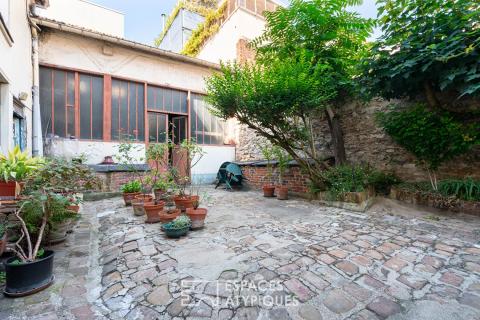 Property complex set around a cobblestone courtyard, in need of renovation